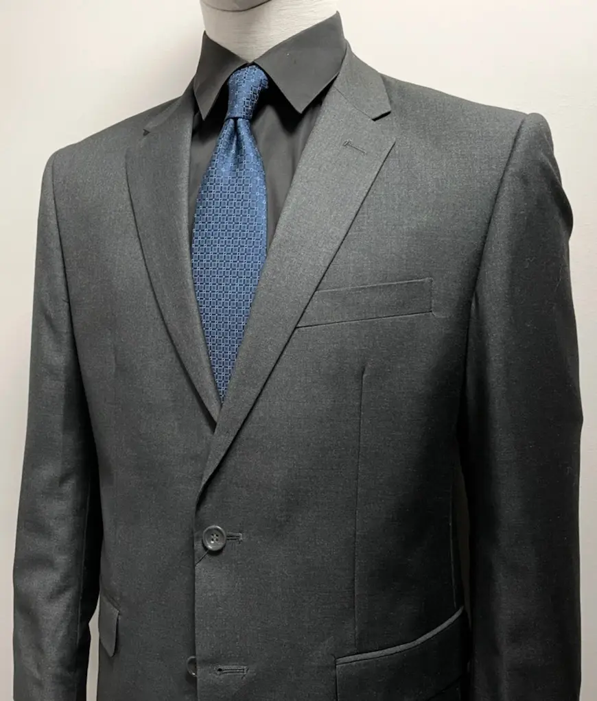 A dark gray suit with a blue tie