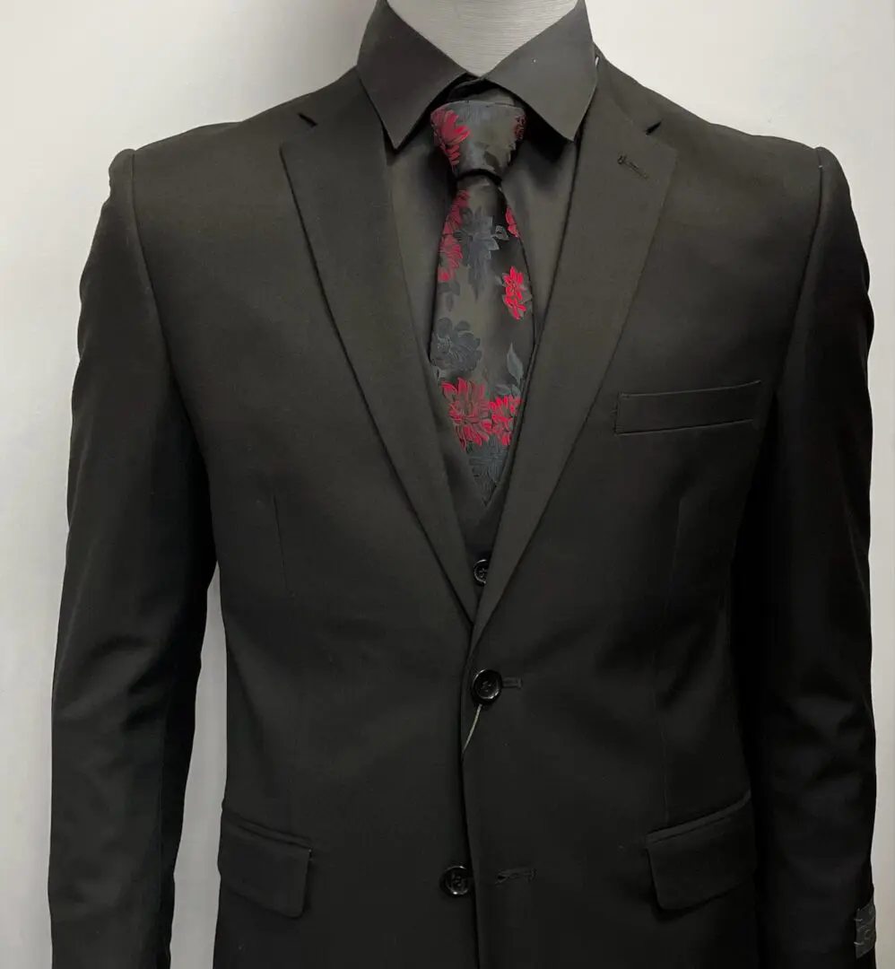 A black suit with a red and black tie
