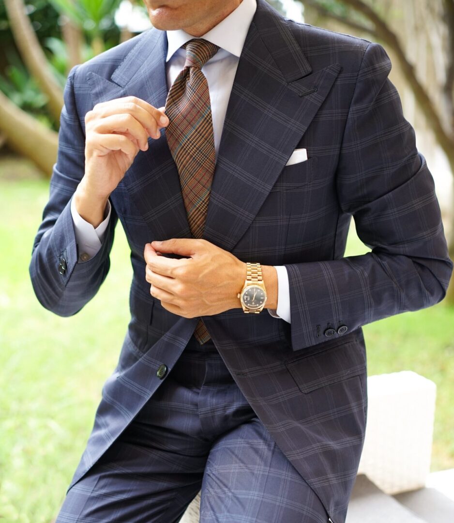 A man in a checkered navy-blue suit