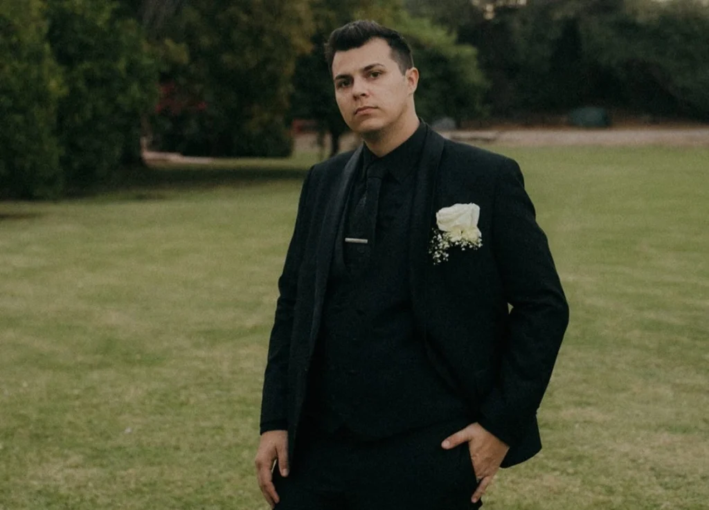 Man Wearing Black Three-Piece Suit With Boutonniere For Cocktail Attire Event In Phoenix Arizona