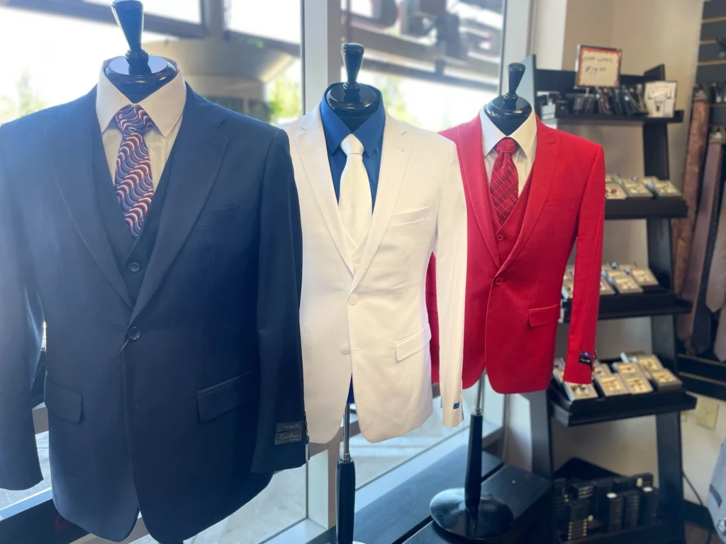 Navy, White, And Red Suit Options For Cocktail Attire Displayed On Mannequins At Van Allan&Amp;Apos;S Mens Fashion Phoenix Showroom