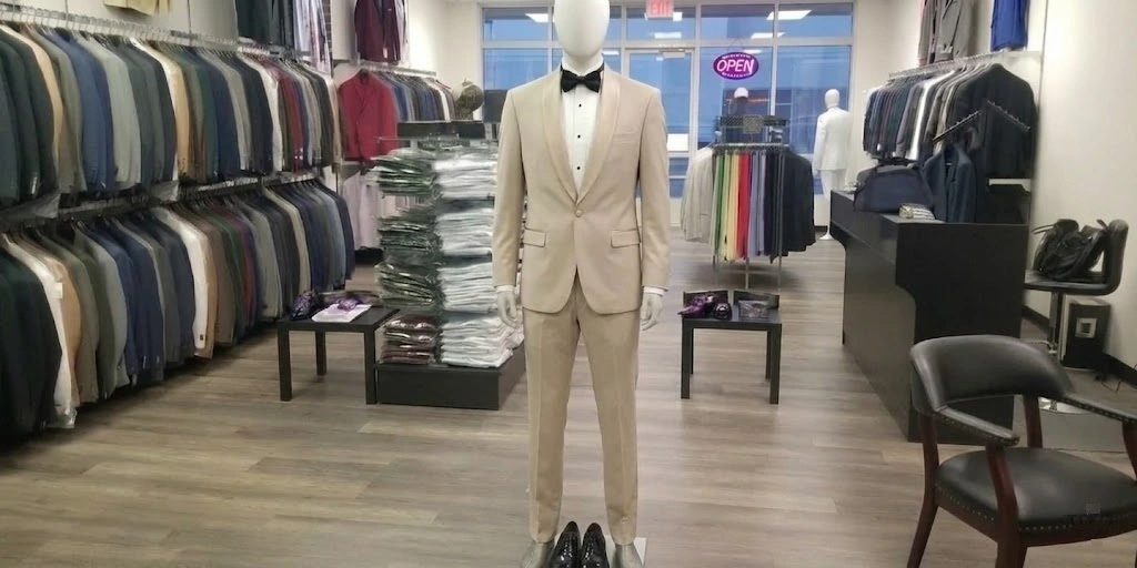 Mannequin Wearing A Tailored Beige Suit With A White Shirt And Black Bow Tie Inside The Van Allan&Amp;Apos;S Mens Fashion Showroom In Phoenix.