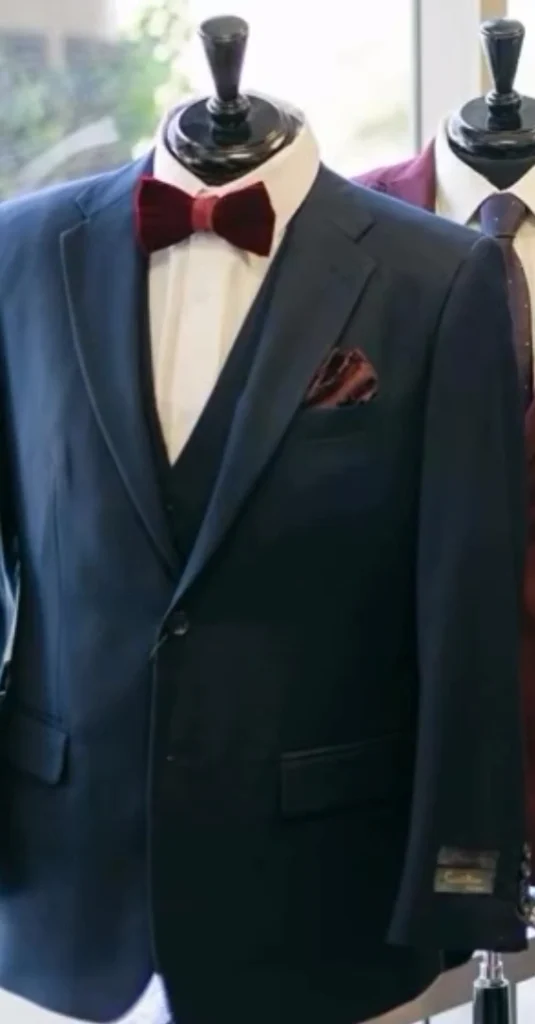 Close Up Of A Deep Navy Blue Tuxedo With A Burgundy Bow Tie On A Mannequin In The Van Allan&Amp;Apos;S Phoenix Showroom.