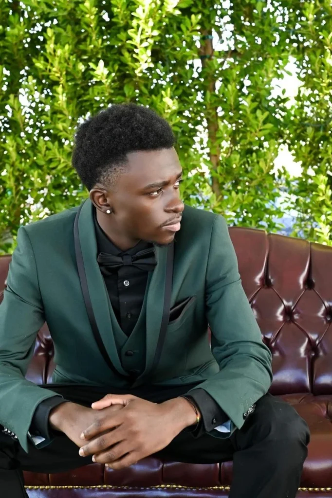 Man in green tuxedo sitting stylishly outdoors – Van Allan’s Men’s Fashion Phoenix