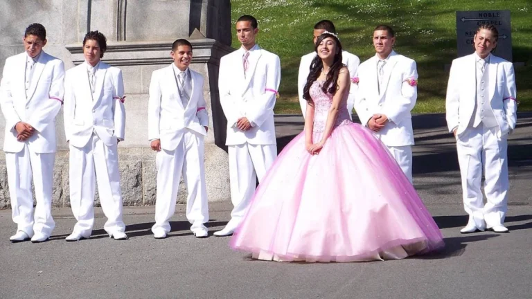 Quinceañera with pink gown and group of boys in white suits – Van Allan’s Men’s Fashion Phoenix