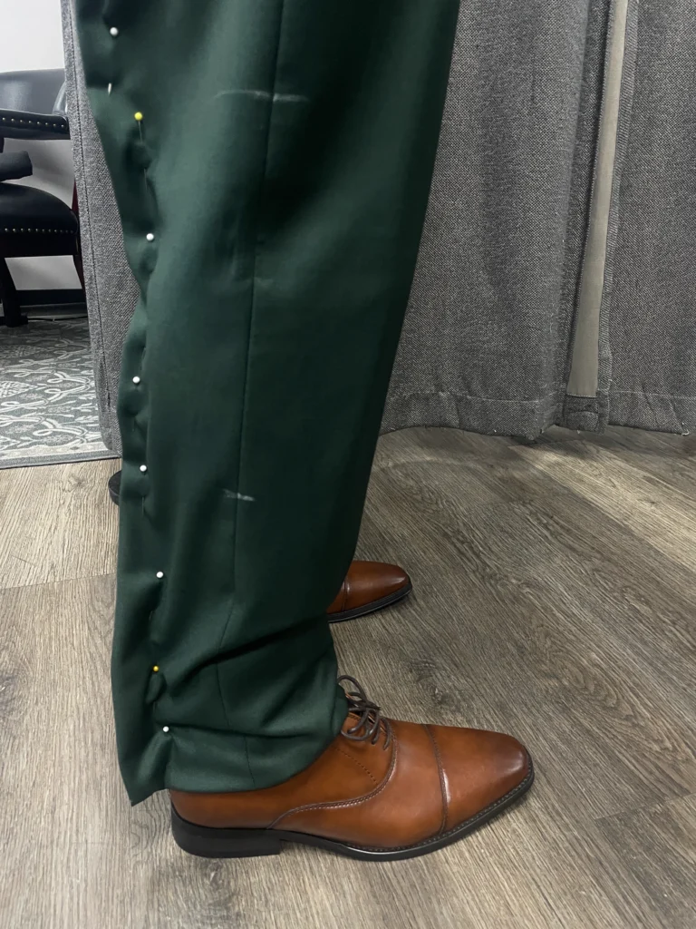 Tailor Pinning The Trouser Hem To Achieve The Perfect Break Over Brown Dress Shoes
