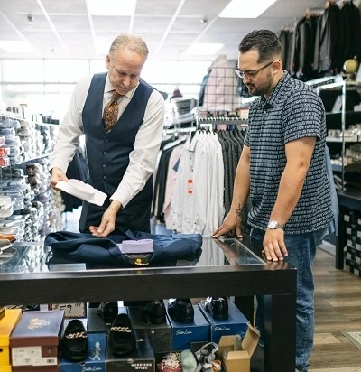 Expert Tailor Measuring Client Inseam For Custom Suit Fitting And Alterations In Phoenix Store