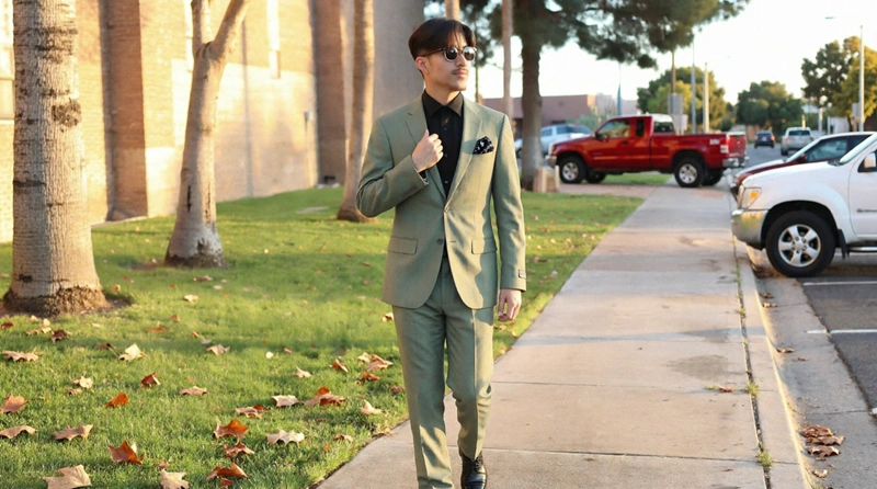 Full-Length Shot Of A Man Walking In A Sage Green Suit With A Black Shirt And Pocket Square In Phoenix