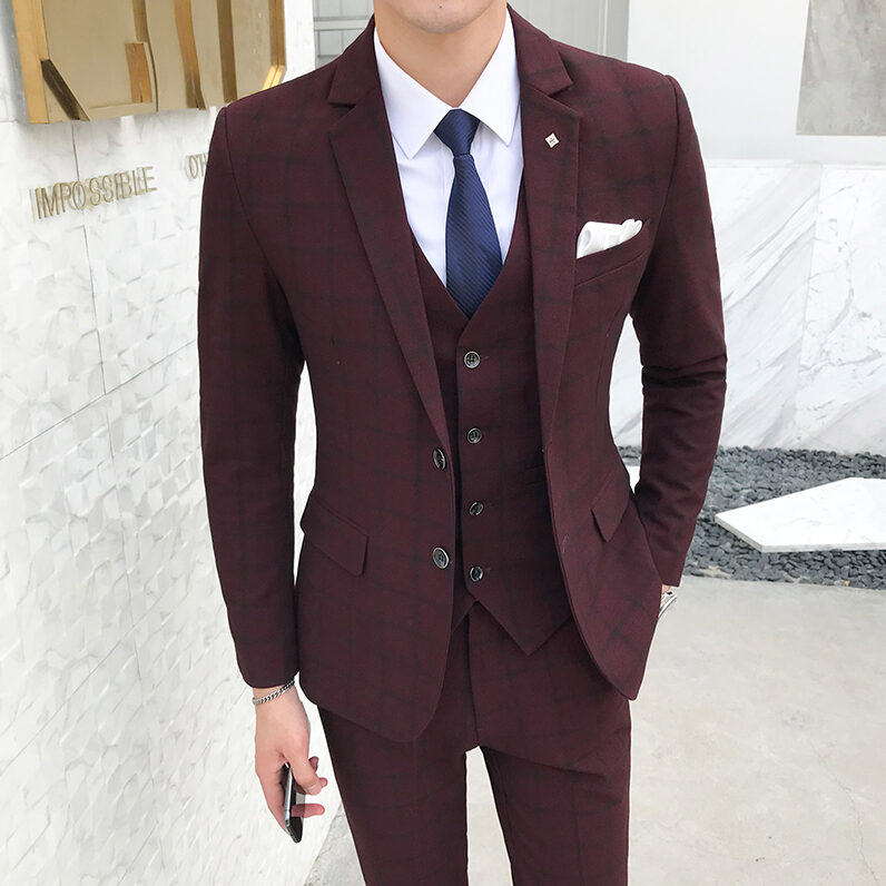 A man in a burgundy suit